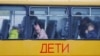 Children evacuated from the Russian-controlled city of Kherson wait in a bus heading to Crimea in the town of Oleshky in October 2022. 
