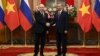 Vietnamese President To Lam shakes hands with Russian President Vladimir Putin in Hanoi on June 20.