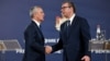 NATO Secretary-General Jens Stoltenberg shakes hands with Serbian President Aleksandar Vucic during a press conference following their meeting in Belgrade on November 21.