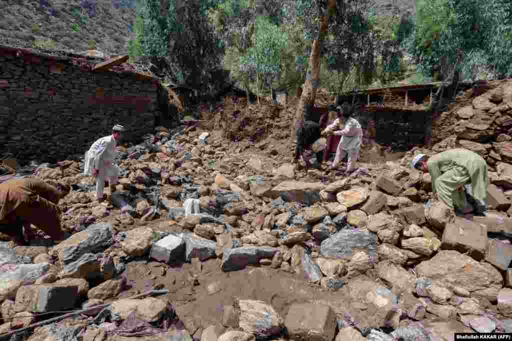 Villagers in the Watapur district of Kunar Province clear debris next to their homes.