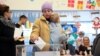 A woman casts her vote at a polling station in Belgrade on December 17.