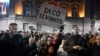 A woman holds a placard reading "Sorry children" as opposition supporters take part in a demonstration outside the Electoral Committee building in Belgrade on December 18.