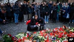 Mourners lay candle lights outside the headquarters of Charles University on December 22 for victims of a mass shooting in Prague the day before. 