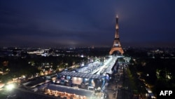 The Summer Olympics' opening ceremony lights up Paris and the Eiffel Tower on July 26.