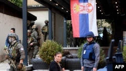 Kosovar police officers search a restaurant and building in a Serb-dominated part of the ethnically divided northern town of Mitrovica on September 29.