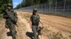 Lithuanian security officers patrol along their country's border with Belarus on July 7. 