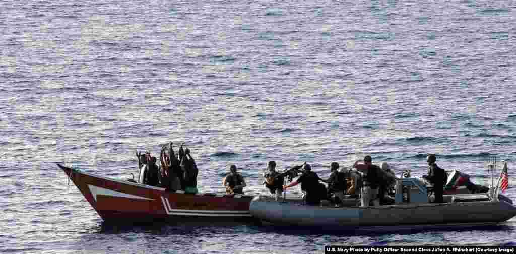 U.S. Coast Guards prepare to board a suspected pirate vessel in the Gulf of Aden in May 2010. NATO was also involved in the operation to crack down on piracy off the coast of Africa from 2008 to 2016. 