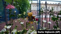 Flowers and toys are placed for the victims near the Vladislav Ribnikar school in Belgrade on May 4, 2023.