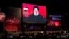 Supporters listen to the speech of Hizballah leader Sayyed Hassan Nasrallah on a video screen in Beirut on August 6.