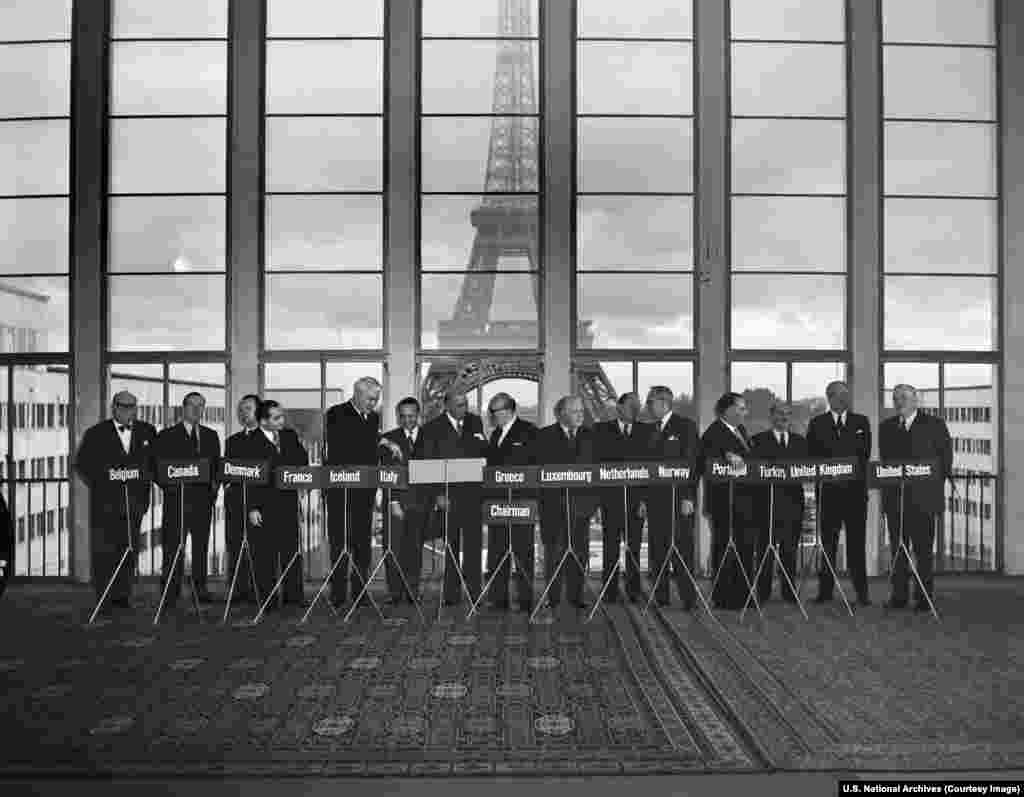 A NATO conference in Paris in 1954. The "North Atlantic" geographical marker of NATO was reportedly chosen so the alliance could remain open to new membership, while discouraging interest from Latin America and far-flung countries like Australia.