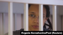 U.S. basketball player Brittney Griner stands inside a defendants' cage during the reading of the court's verdict in Khimki outside Moscow in August.