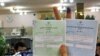 An Iranian voter holds up her ballot at a polling station in Tehran on June 12.