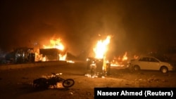 Vehicles on fire after a roadside bomb attack in Quetta that killed at least 15 soldiers and civilians on August 12.