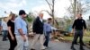 U.S. President Donald Trump walks past hurricane wreckage as he participates in a walking tour in Puerto Rico on October 3.