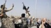 FILE: Afghan civilians cheer their security forces after they killed militants during an attack at Kabul International Airport.