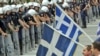 Antiausterity demonstrators confront riot police near the Greek parliament in Athens.