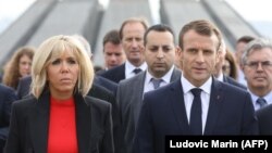French President Emmanuel Macron (left), first lady Brigitte Macron, members of the French delegation, and Armenian officials visit the Tsitsernakaberd Armenian Genocide Memorial in Yerevan in October.