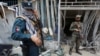 Afghan security personnel inspect the site of a suicide attack outside a bank near the U.S. Embassy in Kabul on August 29.