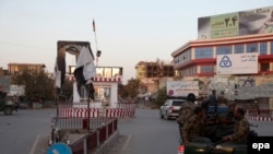 Afghan security forces make their way through a square in the center of Kunduz on October 1.