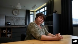 Yelena Koposova sits in her house in the village of Rogaca, Serbia.
