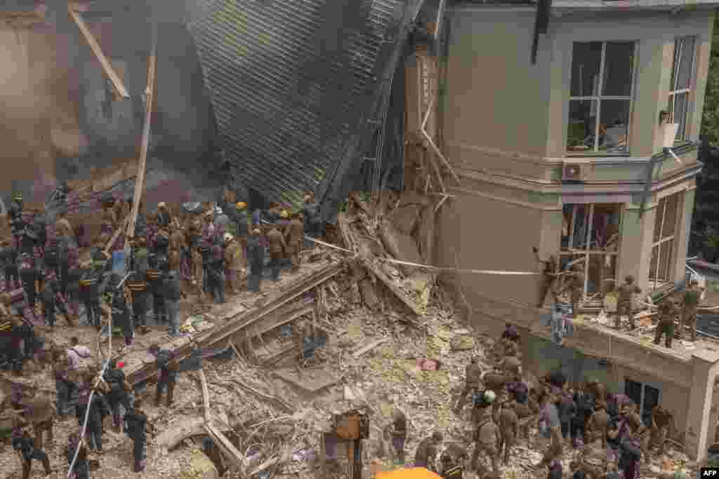 Emergency and rescue personnel clear the rubble of a destroyed building on the campus of the Okhmatdyt children's hospital following a Russian missile attack in the Ukrainian capital on July 8.