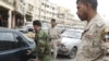 Disarmed members of the Sahwa anti-Qaeda militia man a checkpoint in Baghdad's Fadel district, 02Apr2009