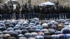 Israeli riot police keep watch as Palestinian Muslim worshippers pray outside Jerusalem's old city on July 28, 2017.