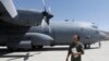 An Afghan Air Force pilot checks a C-130 military transport plane. (file photo)