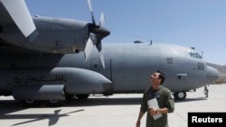 An Afghan Air Force pilot checks a C-130 military transport plane. (file photo)