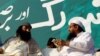 FILE: Hizb ul-Mujahideen chief Syed Salahuddin (L), speaking with Hafiz Muhammad Saeed, chief of the Jamaat-ud-Dawa during a protest in Islamabad.