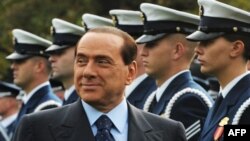 Italian Prime Minister Silvio Berlusconi inspects the honor guard during a welcome ceremony at the White House in October 2008.