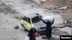 Siriýanyň ýarym weýran bolan Aleppo şäherindäki aýallar
