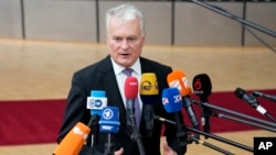 Lithuanian President Gitanas Nauseda speaks with the media as he arrives for an EU summit at the European Council building in Brussels on June 29.