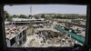 FILE: Workers remove debris from a damaged area a day after a suicide bomb attack near the foreign embassies in Kabul, Afghanistan on June 1.