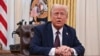 U.S. President Donald Trump speaks to the media in the Oval Office of the White House on January 23.
