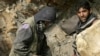 Afghan miners drill into rock in a makeshift emerald mine in the Panjshir Valley (file photo)