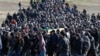 Crimean Tatars gather for the funeral of Reshat Ametov -- whose naked, bound, and apparently tortured body was discovered outside Simferopol -- on March 18.