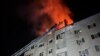 Firefighters work to extinguish a blaze at a residential building hit by a Russian drone attack in Mykolayiv, Ukraine, early on January 22.