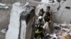 Rescue workers deal with the aftermath of a Russian drone attack on the Ukrainian city of Sumy on January 30. 