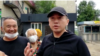 Aset Abishev speaks to reporters after his release from prison on July 30. 