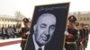 Army officers carry a portrait of former President Mohammad Daud Khan during his funeral in Kabul.