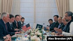 U.S. Secretary of State Rex Tillerson (L) sits across from Pakistani Prime Minister Shahid Khan Abbasi (R) during their meeting with delegations, at the Prime Minister's residence, in Islamabad on October 24.