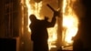 A rioter throws a street sign into the burning U.S. Embassy in Belgrade, Serbia, in February 2008. 