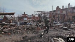 A handout image from Russia's Defense Ministry shows Russian troops in the town of Sudzha on March 13. 