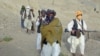 Taliban spokesman Zabihullah Mujahid with fellow militants in Helmand Province