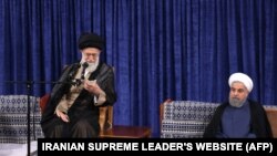 A handout picture released by the official website of the Iranian supreme leader Ayatollah Ali Khamenei shows him (L) speaking during the swearing in ceremony of Iranian President Hasan Rouhani (R) in Tehran on August 3.