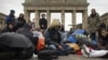 FILE: Afghan refugees protest in front of the Brandenburg Gate in Berlin.