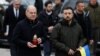 Ukrainian President Volodymyr Zelenskiy (right) and German Chancellor Olaf Scholz visit a makeshift memorial to fallen soldiers on Independence Square in Kyiv on December 2. 