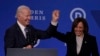 U.S. Vice President Kamala Harris (right) and President Joe Biden hold hands at the Democratic National Committee 2023 Winter meeting in Philadelphia, Pennsylvania, in February 2023.