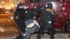 Riot police break up postelection protests in downtown Minsk on December 19.